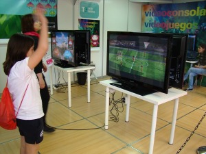 Una nia juega al ftbol en la videoconsola del taller de Ocio Digital